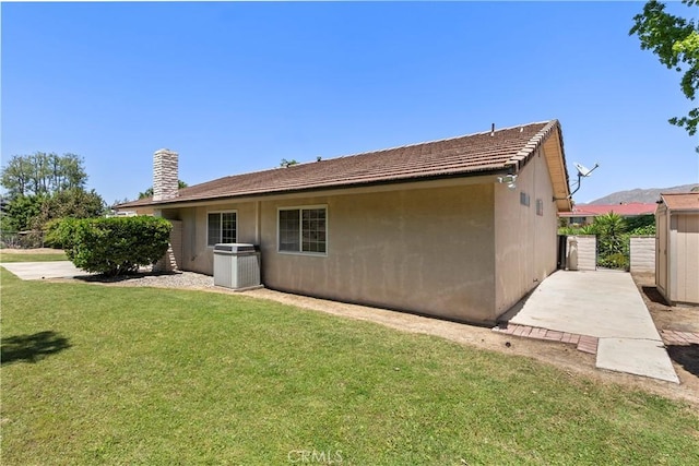 5655 Via Mensabe, Riverside, CA 92506 - back of house featuring a yard, stucco siding, a patio area, and central AC unit