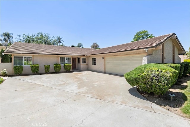 5655 Via Mensabe, Riverside, CA 92506 - single story home with stucco siding, a tile roof, a garage, and driveway