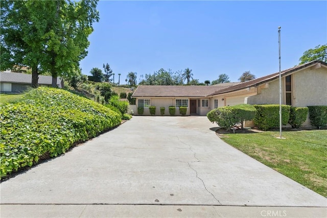 5655 Via Mensabe, Riverside, CA 92506 - single story home with concrete driveway, a garage, stucco siding, and a front yard