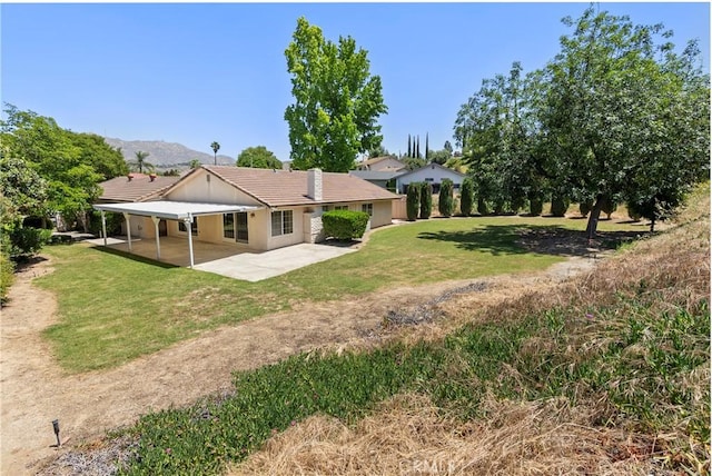 5655 Via Mensabe, Riverside, CA 92506 - back of house with a patio, a tile roof, a carport, a yard, and driveway