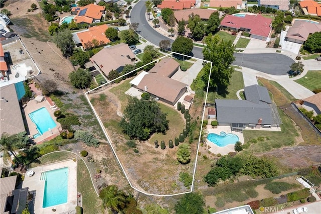 5655 Via Mensabe, Riverside, CA 92506 - aerial view of property and surrounding area with a pool area, property boundaries highlighted, and nearby suburban area