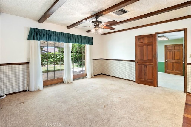 5655 Via Mensabe, Riverside, CA 92506 - carpeted empty room with beamed ceiling, ceiling fan, a wainscoted wall, and a textured ceiling
