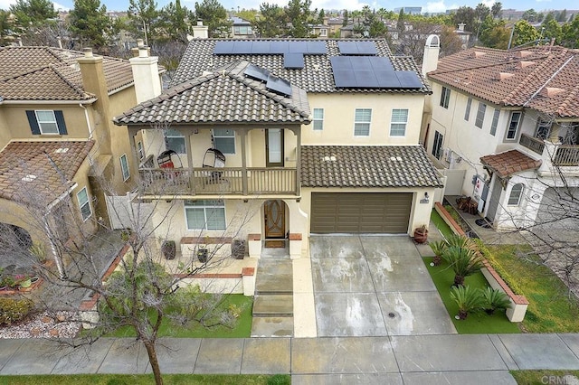 1693 Thompson Ave, Chula Vista, CA 91913 - mediterranean / spanish-style house with a balcony, stucco siding, driveway, roof mounted solar panels, and a chimney