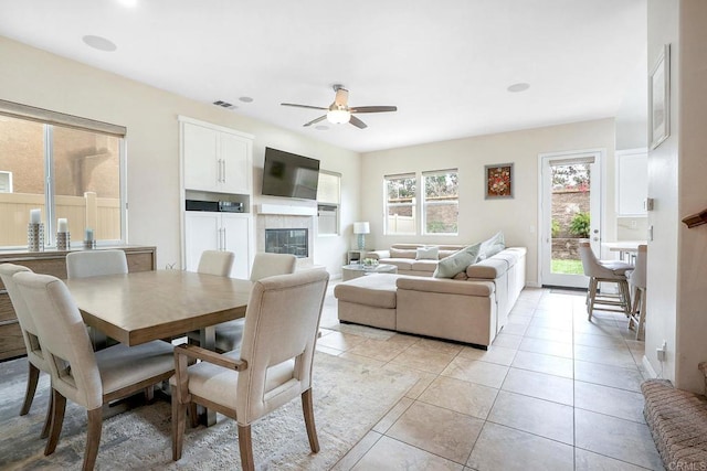 1693 Thompson Ave, Chula Vista, CA 91913 - dining space featuring ceiling fan, a glass covered fireplace, and light tile patterned floors