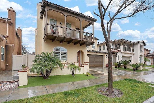 1693 Thompson Ave, Chula Vista, CA 91913 - view of front facade with a balcony, an attached garage, stucco siding, driveway, and a tile roof