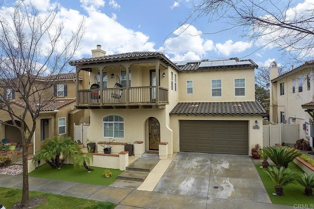 1693 Thompson Ave, Chula Vista, CA 91913 - mediterranean / spanish-style home with a balcony, roof mounted solar panels, a chimney, and a tile roof