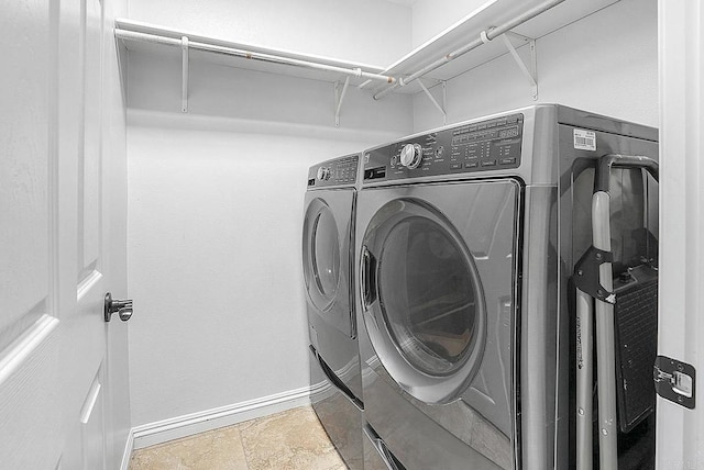 1693 Thompson Ave, Chula Vista, CA 91913 - washroom with washer and clothes dryer and stone finish flooring