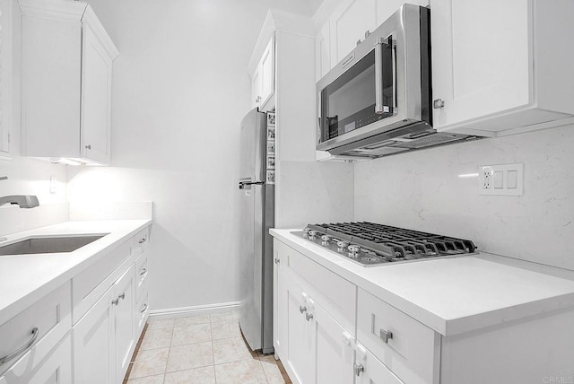1693 Thompson Ave, Chula Vista, CA 91913 - kitchen with appliances with stainless steel finishes, white cabinetry, and light countertops