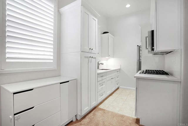 1693 Thompson Ave, Chula Vista, CA 91913 - kitchen featuring appliances with stainless steel finishes, white cabinets, light countertops, light tile patterned floors, and recessed lighting