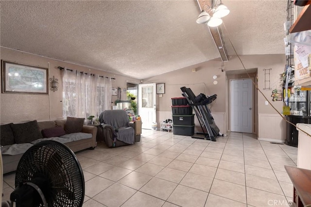 323 Whipple Mountain Rd, San Bernardino, CA 92410 - living room with a textured ceiling, lofted ceiling, light tile patterned flooring, and a wainscoted wall