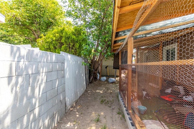 323 Whipple Mountain Rd, San Bernardino, CA 92410 - view of side of home featuring fence, exterior structure, and an outdoor structure