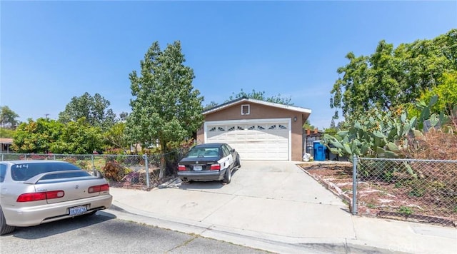 323 Whipple Mountain Rd, San Bernardino, CA 92410 - view of front facade featuring concrete driveway, fence, and stucco siding