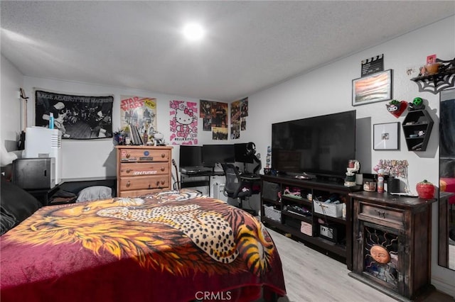323 Whipple Mountain Rd, San Bernardino, CA 92410 - bedroom with a textured ceiling and wood finished floors