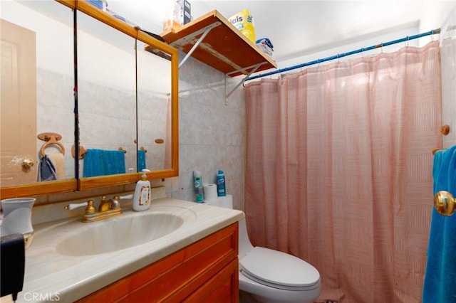 323 Whipple Mountain Rd, San Bernardino, CA 92410 - bathroom with toilet, tile walls, curtained shower, and vanity