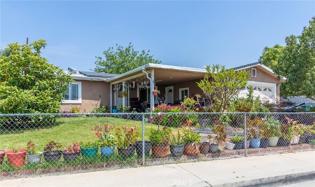 323 Whipple Mountain Rd, San Bernardino, CA 92410 - view of front of property with solar panels, stucco siding, fence private yard, and a front yard