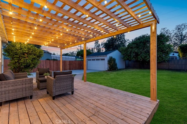 deck featuring a fenced backyard, an outdoor structure, a pergola, and a yard