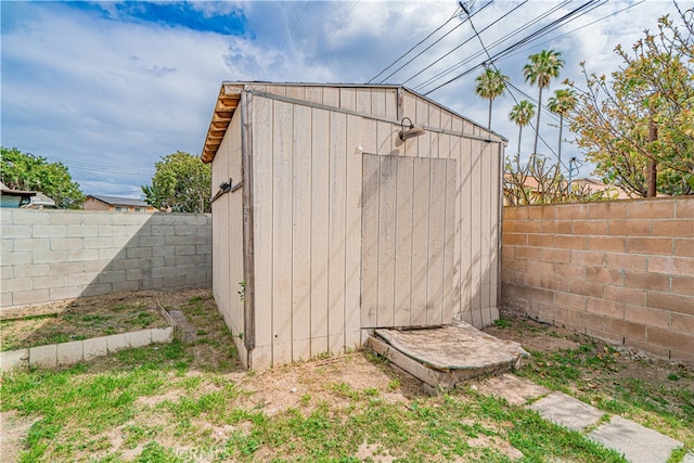 view of shed with a fenced backyard