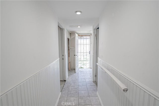 hall with light tile patterned floors