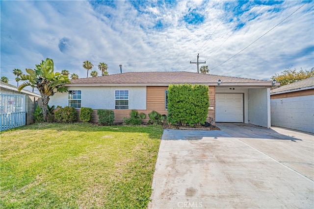 ranch-style house featuring a garage, fence, a front yard, stucco siding, and concrete driveway
