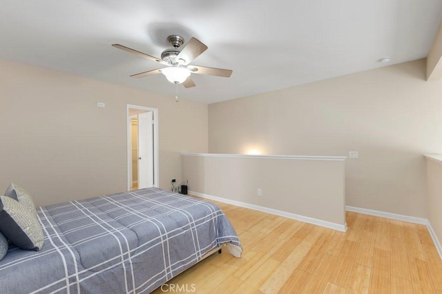 bedroom featuring baseboards, a ceiling fan, and wood finished floors