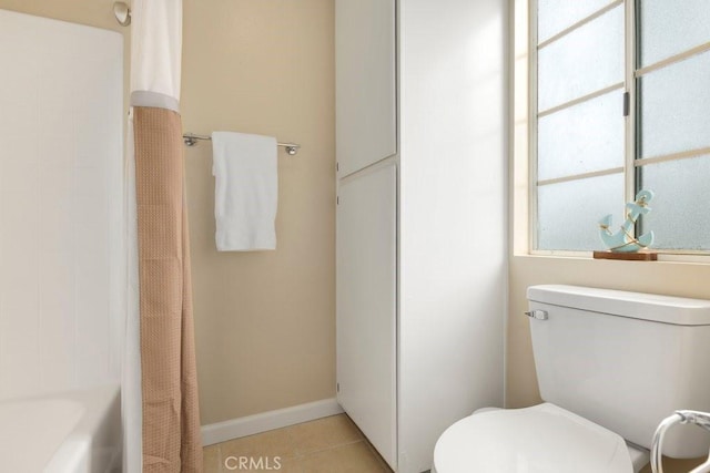 full bathroom with baseboards, tile patterned flooring, and toilet