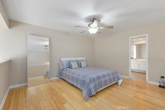 bedroom featuring baseboards, ceiling fan, wood finished floors, and connected bathroom