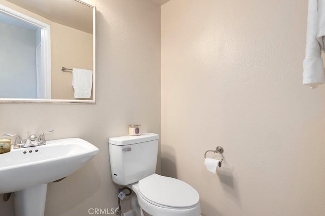 bathroom featuring a sink and toilet