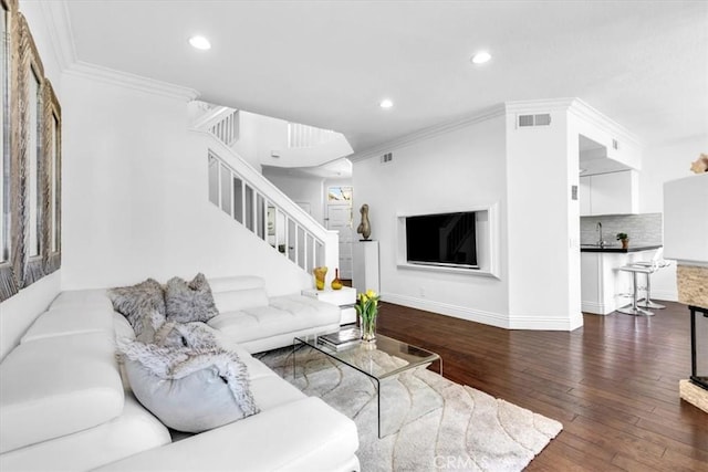 living room featuring stairway, visible vents, hardwood / wood-style flooring, and recessed lighting