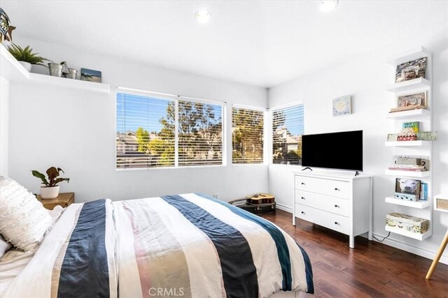 bedroom with wood finished floors and recessed lighting