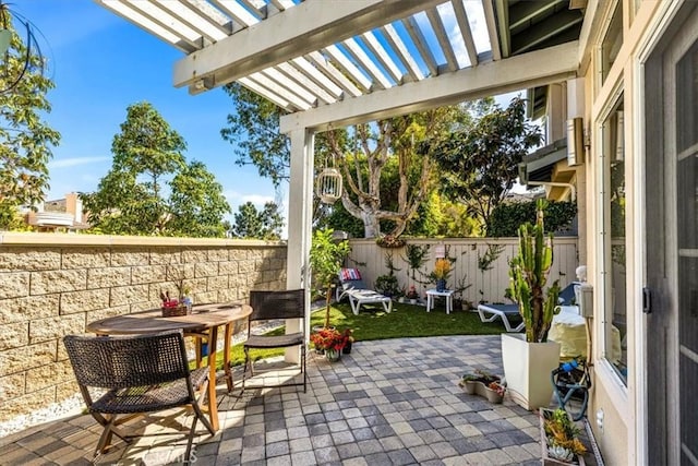 view of patio with a fenced backyard, outdoor dining area, and a pergola