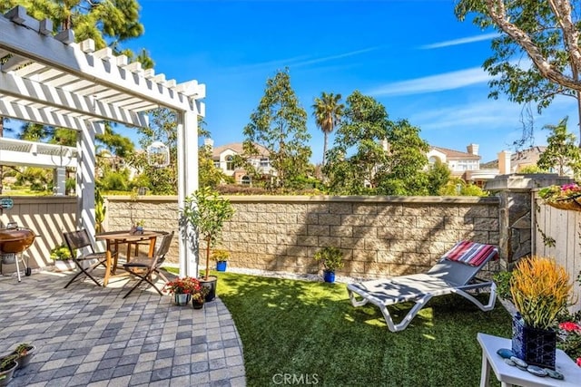 view of yard featuring a patio, fence, and a pergola