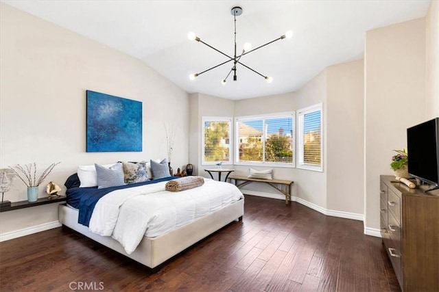 bedroom featuring baseboards, a notable chandelier, lofted ceiling, and dark wood-style floors