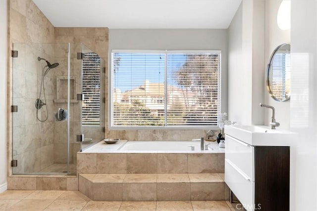 bathroom featuring a shower stall, a garden tub, tile patterned flooring, and vanity