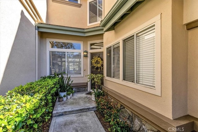 property entrance with stucco siding