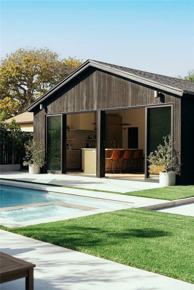6144 W 76th St, Los Angeles, CA 90045 - back of house featuring an outdoor pool, an outbuilding, a yard, and a garage