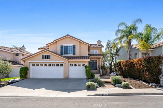 43 La Sordina, Rancho Santa Margarita, CA 92688 - view of front of home featuring a chimney, stucco siding, driveway, a tile roof, and fence
