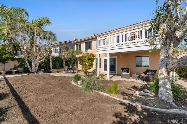 43 La Sordina, Rancho Santa Margarita, CA 92688 - rear view of house with a patio, stucco siding, a balcony, outdoor lounge area, and fence