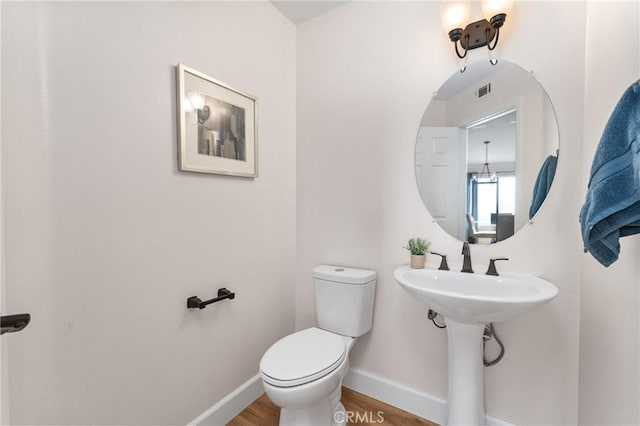 43 La Sordina, Rancho Santa Margarita, CA 92688 - half bathroom with baseboards, toilet, and wood finished floors