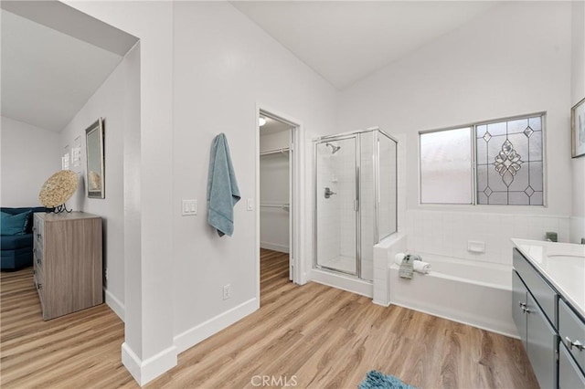43 La Sordina, Rancho Santa Margarita, CA 92688 - bathroom with a shower stall, wood finished floors, vanity, a garden tub, and vaulted ceiling