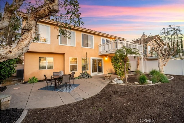 43 La Sordina, Rancho Santa Margarita, CA 92688 - back of property featuring a balcony, stucco siding, fence, and a patio area