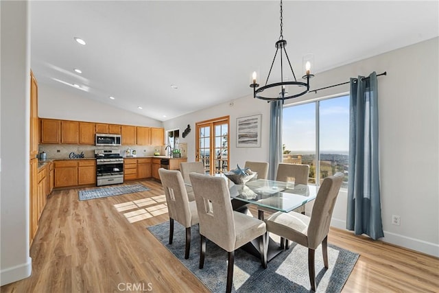 43 La Sordina, Rancho Santa Margarita, CA 92688 - dining area with vaulted ceiling, a chandelier, light wood-style flooring, baseboards, and recessed lighting