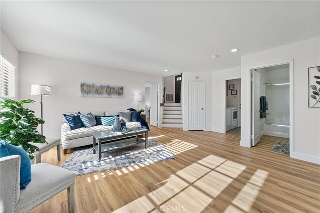 43 La Sordina, Rancho Santa Margarita, CA 92688 - living area featuring washing machine and clothes dryer, stairs, light wood-type flooring, baseboards, and recessed lighting