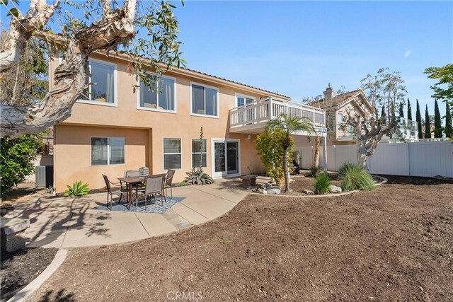 43 La Sordina, Rancho Santa Margarita, CA 92688 - rear view of house with stucco siding, fence, a patio, and a balcony
