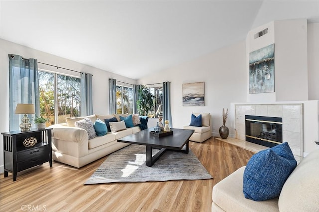 43 La Sordina, Rancho Santa Margarita, CA 92688 - living area featuring vaulted ceiling, wood finished floors, and a tile fireplace
