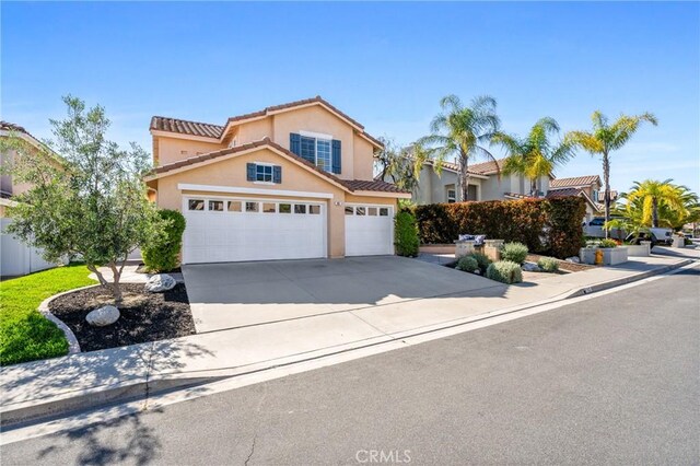 43 La Sordina, Rancho Santa Margarita, CA 92688 - view of front of property with concrete driveway, an attached garage, stucco siding, and a tile roof
