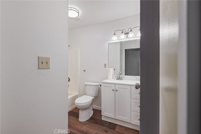 bathroom featuring vanity, shower / bath combination, wood finished floors, and toilet