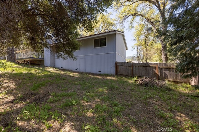 view of property exterior with fence and crawl space