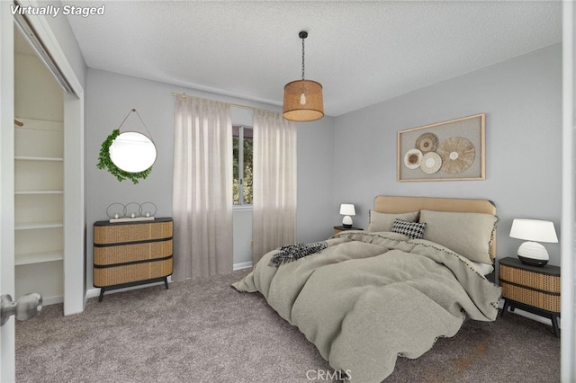 bedroom featuring carpet floors and a textured ceiling