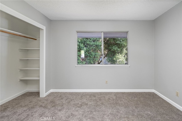 unfurnished bedroom with baseboards, carpet, a closet, and a textured ceiling