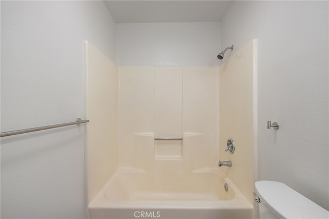 bathroom with toilet and shower / washtub combination